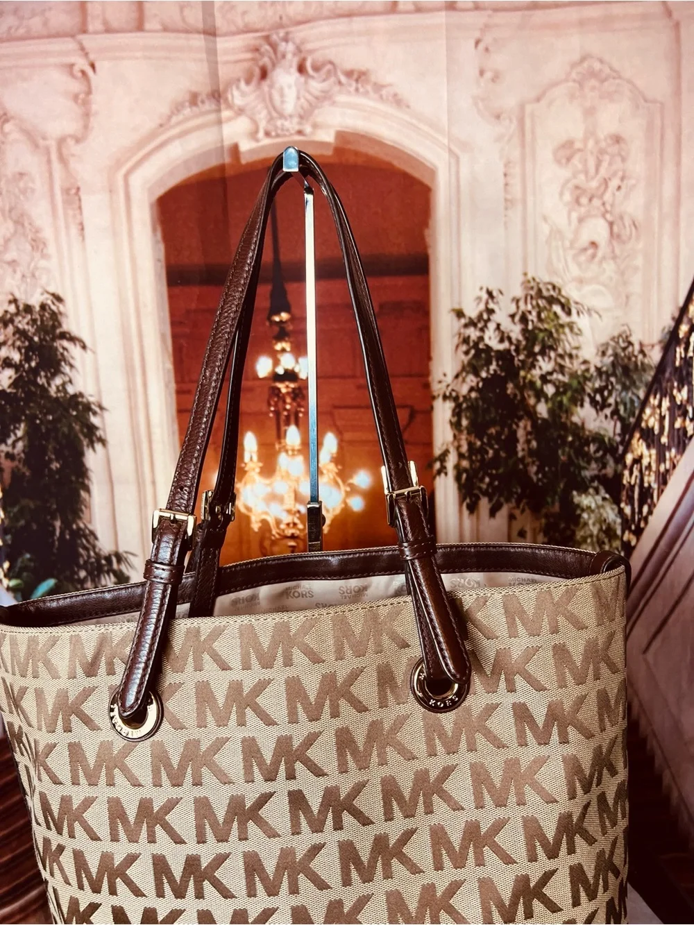 Michael Kors Jet Set tote features monogram canvas, contrasting leather straps